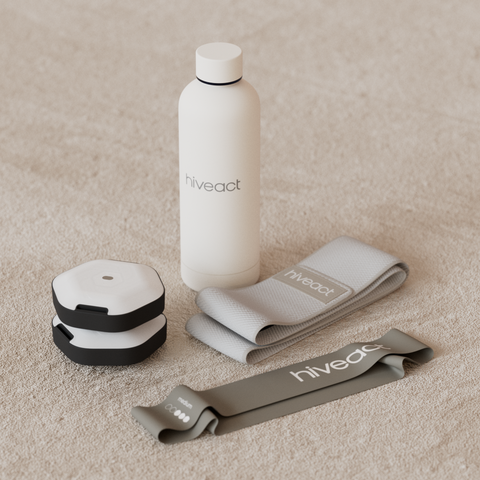 White water bottle and gray resistance bands with 'hivveact' branding on a beige surface.