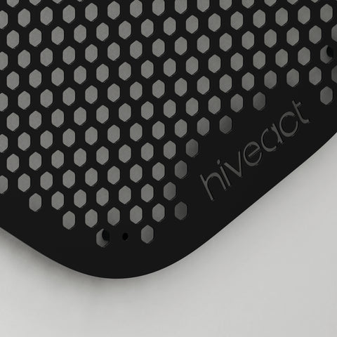 Close-up of Hiveact wall reaction board showing metal hex grid and magnetic mounting surface