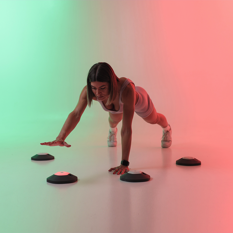 Woman performing a workout with Reaction Lights and black magnetic bases